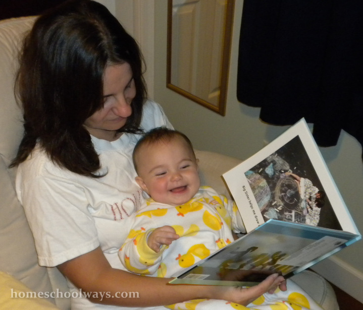 Mom reads to infant baby girl