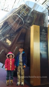Boy and girl in front of Apollo 11