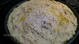 Olive oil and basil sprinkled over chickpea paste