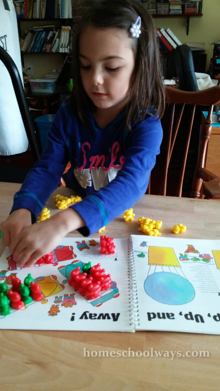 Girl counting with math teddy bears