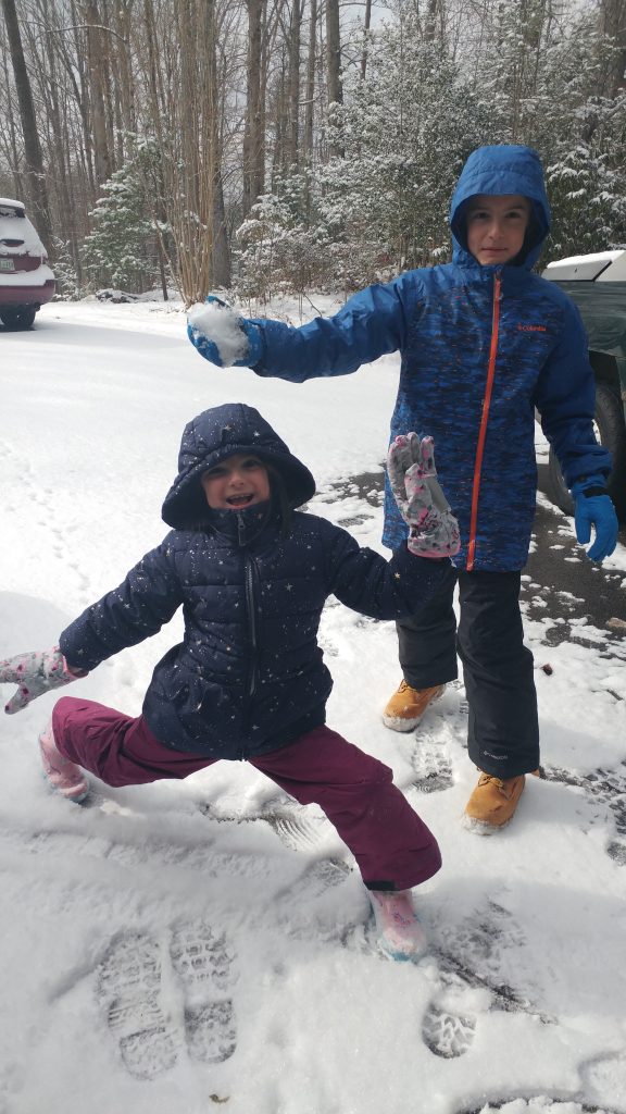 Boy and girl playing in the snow
