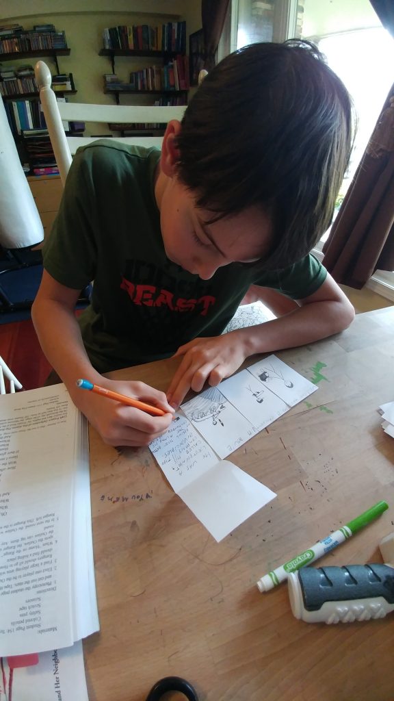 Boy writes in flip book