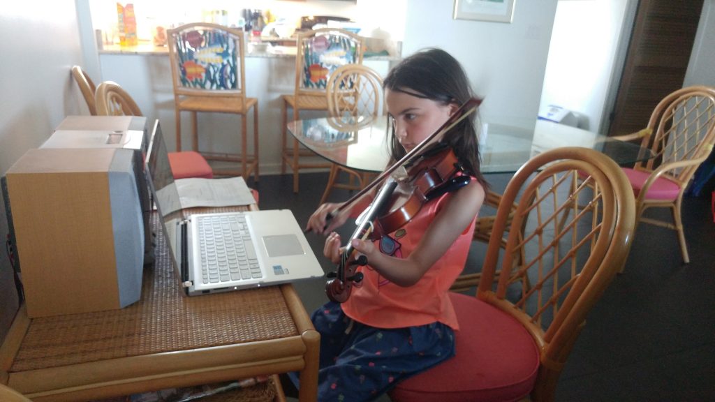 Girl practices violin