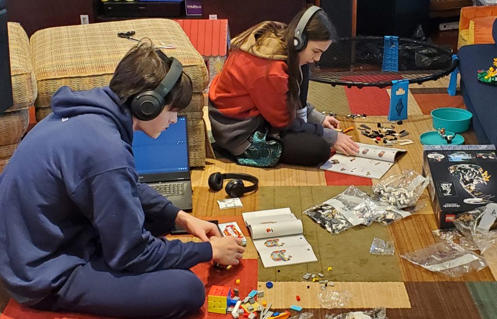Teens building LEGO kits