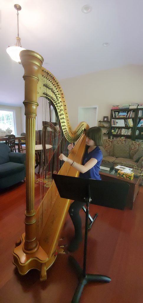 Girl playing a pedal harp