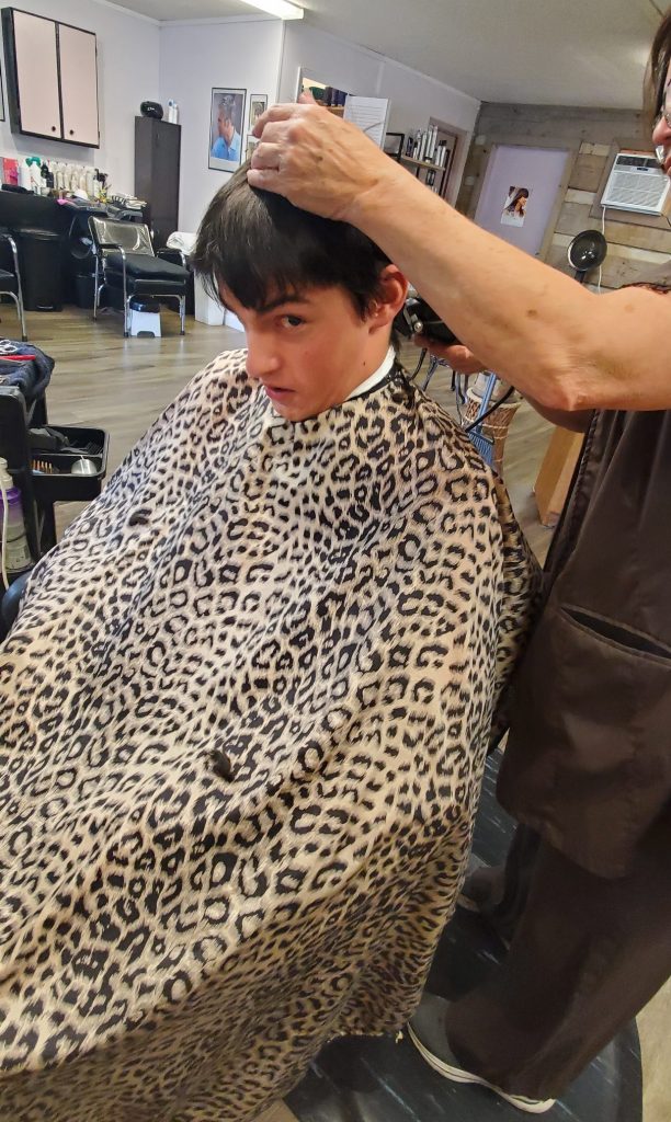Teenage boy getting a haircut