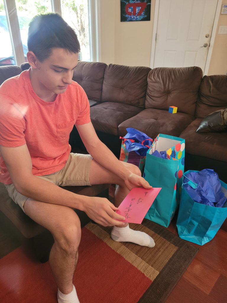 Teenager opens gifts
